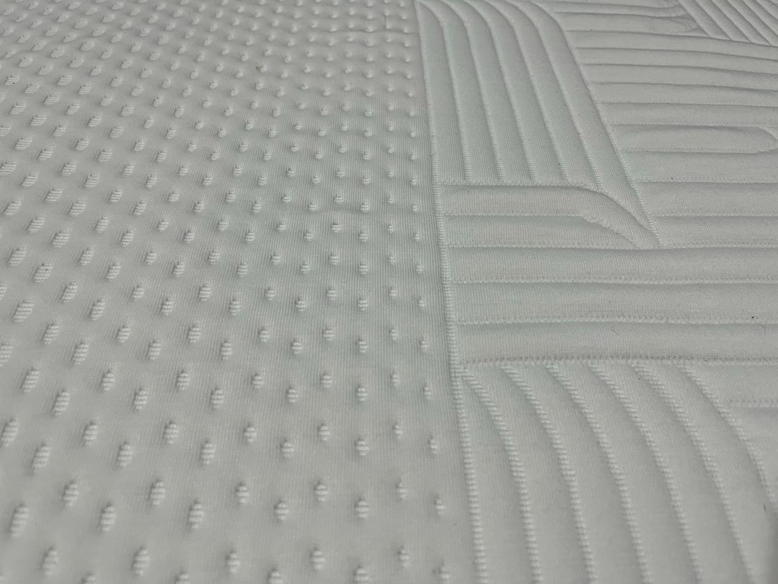 Macro close-up of the top cover, showing raised micro-dots beside the quilted channels.